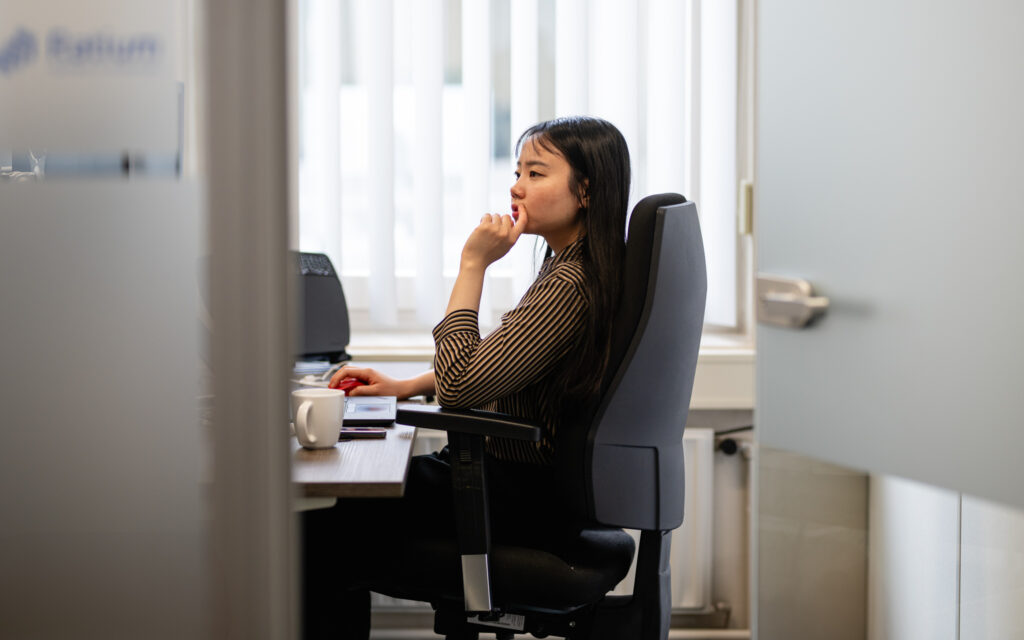 Vrouw werkt aan computer in kantoor.